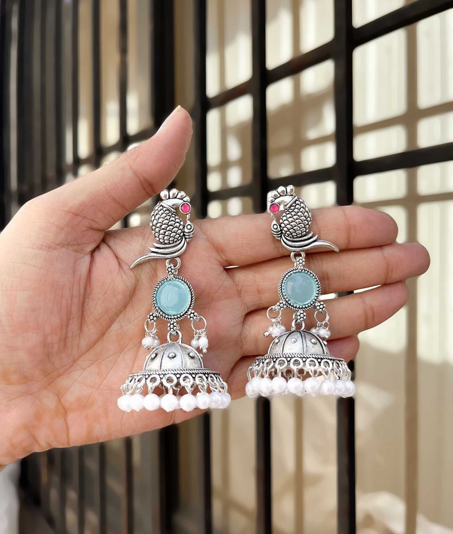 Oxidized Silver Peacock Jhumka Earrings with Blue Stone & Pearl Detailing
